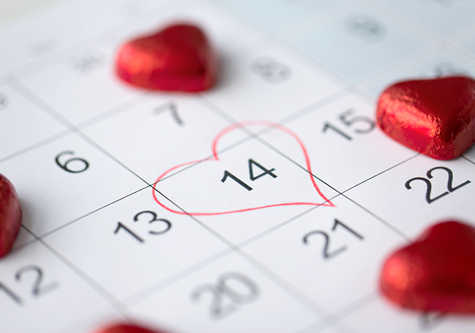 Valentines Day 14th February circled date in calendar with red heart chocolates