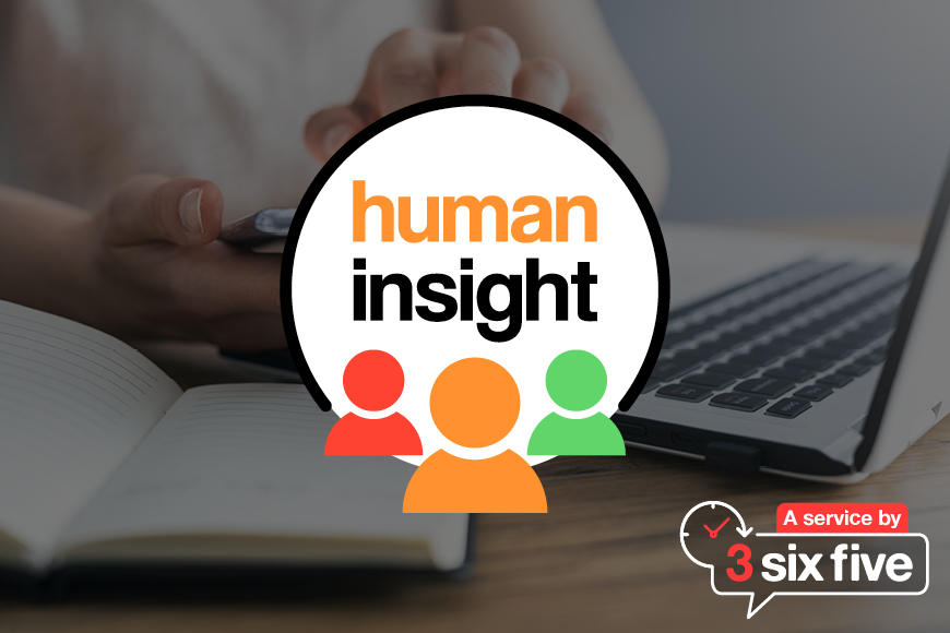 Female hands holding smartphone beside laptop with Human Insight logo on top