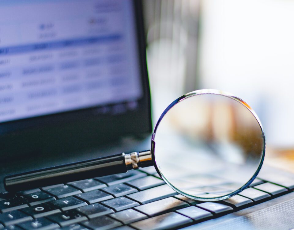 Magnifying glass on laptop keyboard