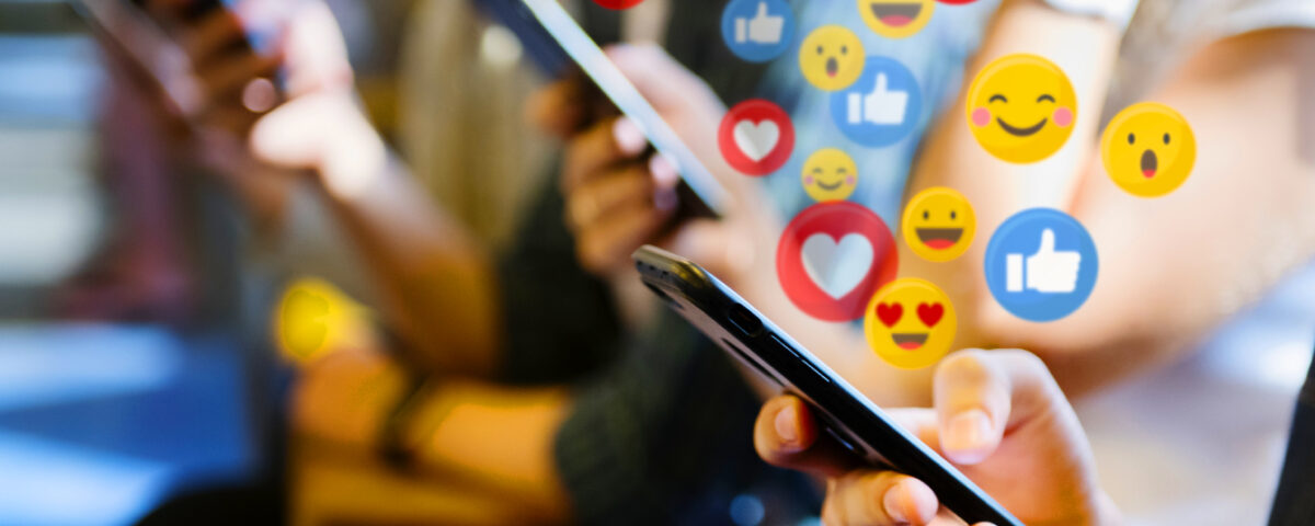 Social media reaction icons around smartphone