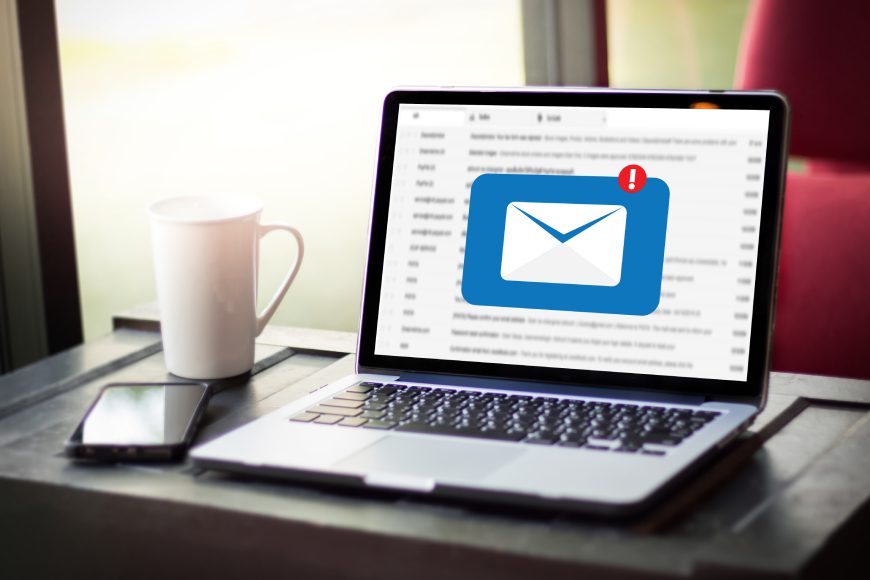 Laptop with inbox message envelope notification on screen