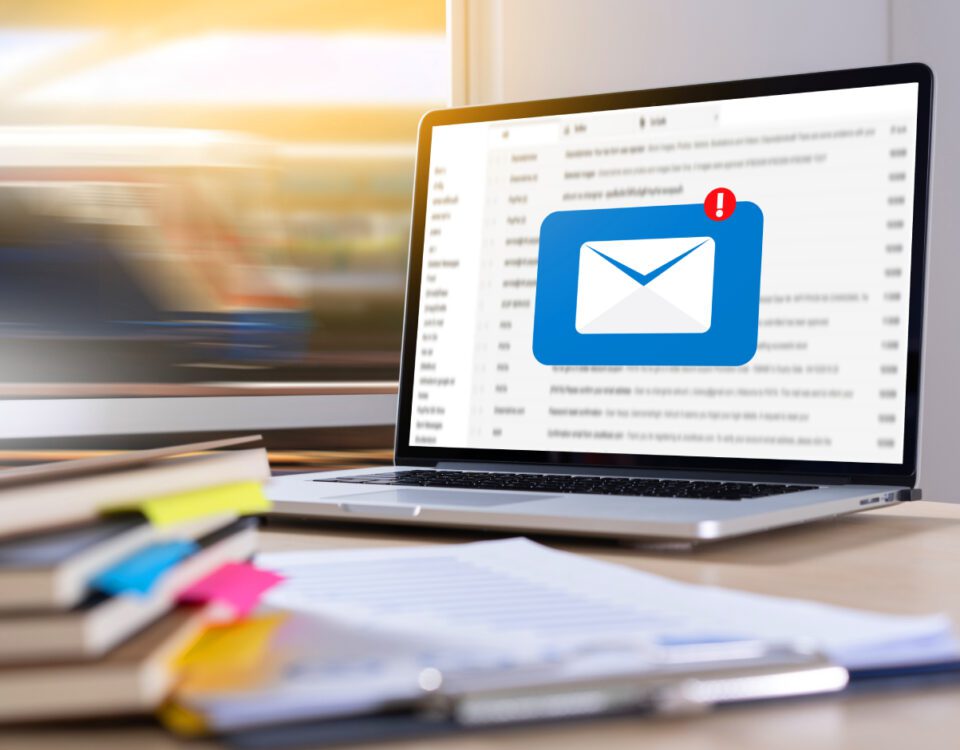 Laptop on desk with envelope inbox notification icon on screen