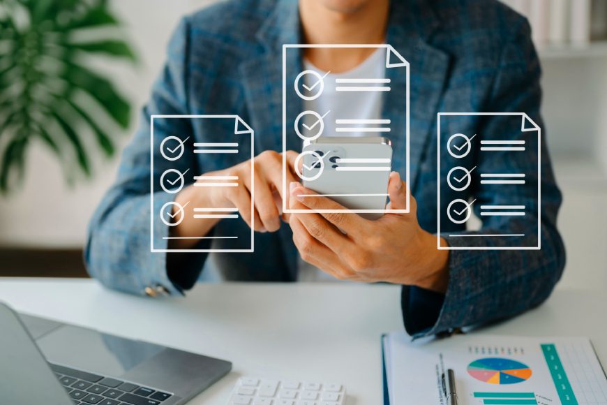 Woman sitting at desk using smartphone with white document icons overlaid