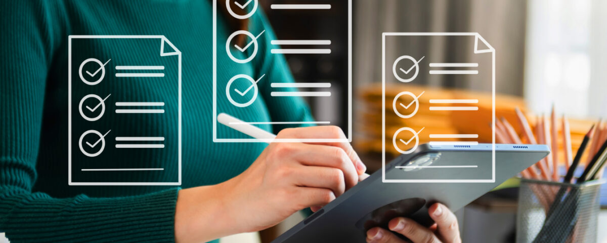 Woman sitting at desk using iPad tablet with stylus pen and white document icons overlaid