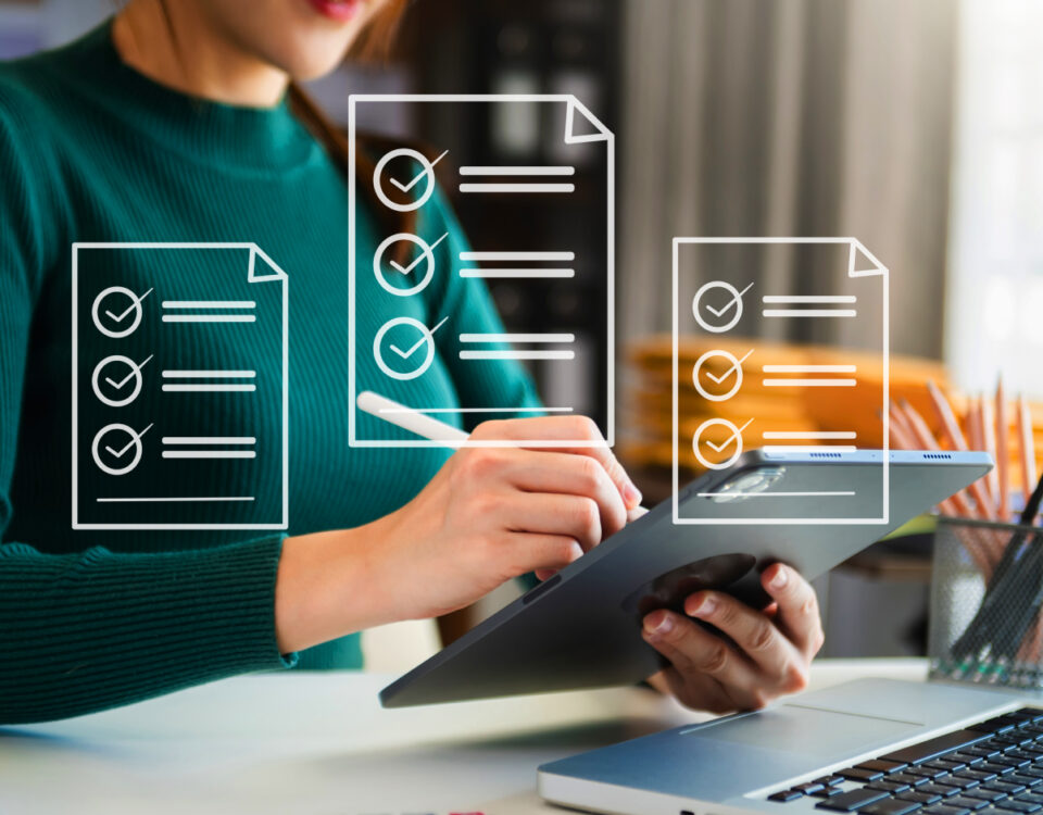 Woman sitting at desk using iPad tablet with stylus pen and white document icons overlaid